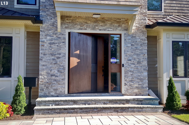 Mehta Pivot Door in Walnut featuring our custom black powder coated steel handle and Custom Right Sidelight